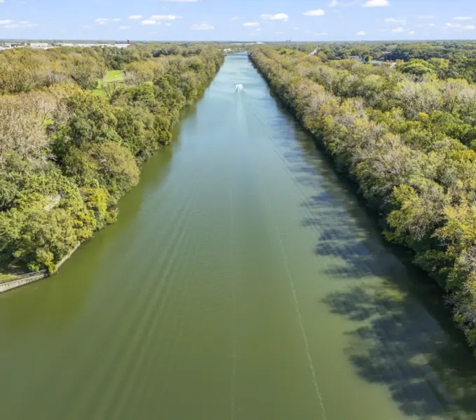 wide river with forest on either side and bot moving down the middle